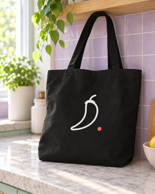 Back of the black Neurospicy. tote bag with the white line chilli and orange full stop