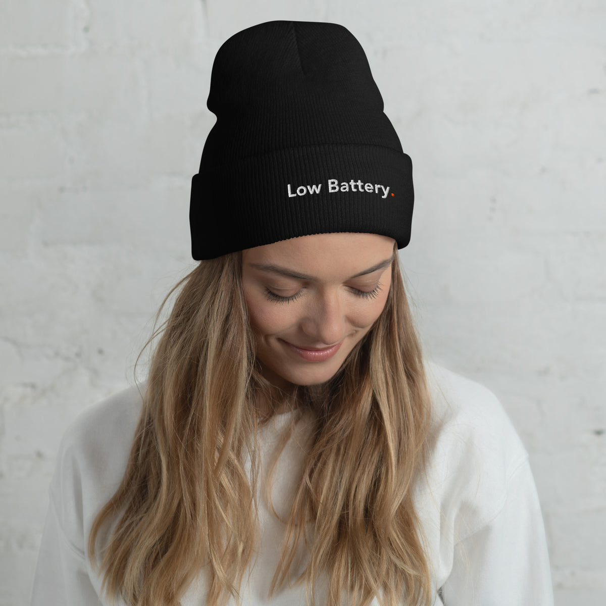 Woman wearing the black Low Battery. embroidered beanie