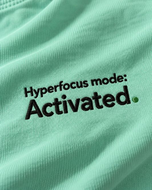 Close-up of the Hyperfocus mode: Activated. embroidery on Chalky Mint fabric