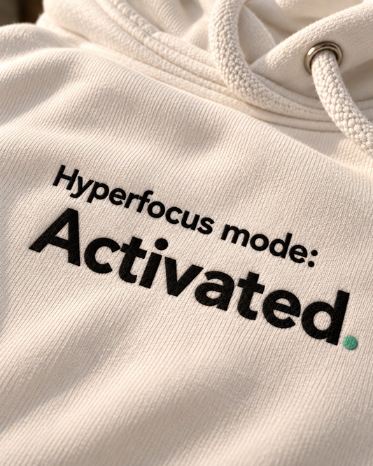 Close-up of the Hyperfocus mode: Activated. embroidery on the white hoodie