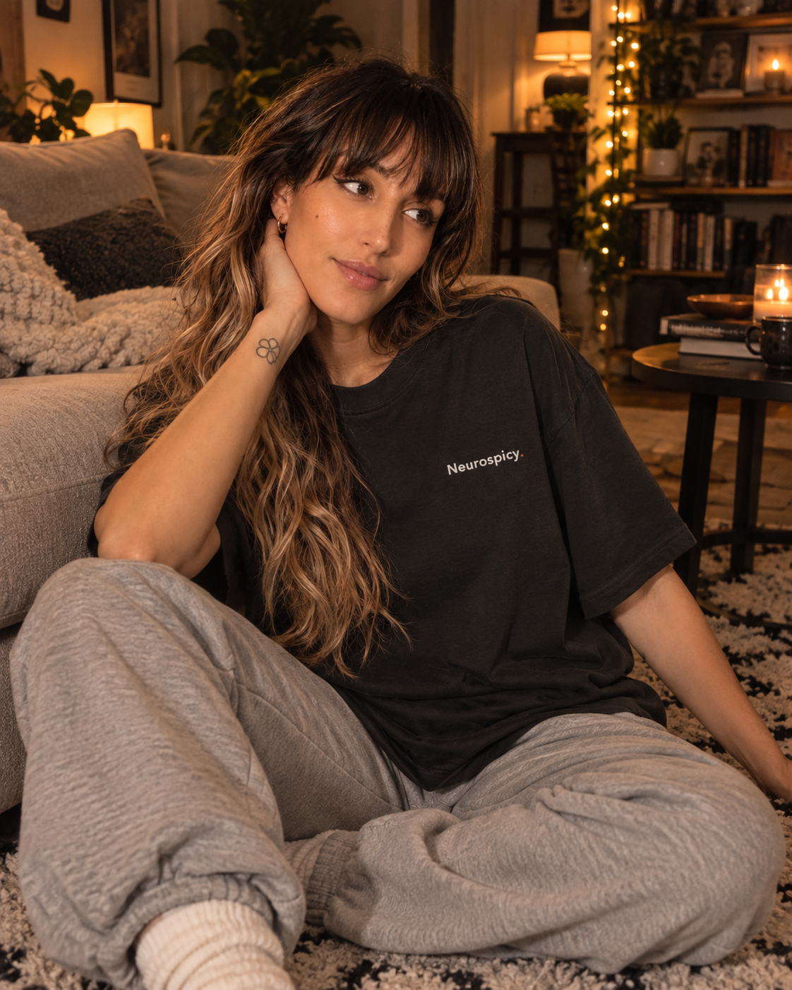 Woman relaxing at home in the Neurospicy. oversized tee in Washed Black