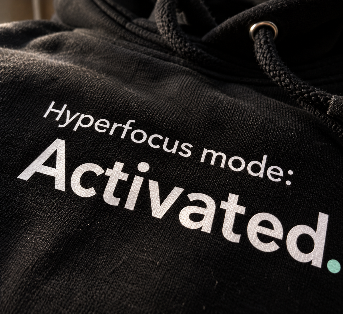 Close-up of the Hyperfocus mode: Activated. chest print on the black hoodie