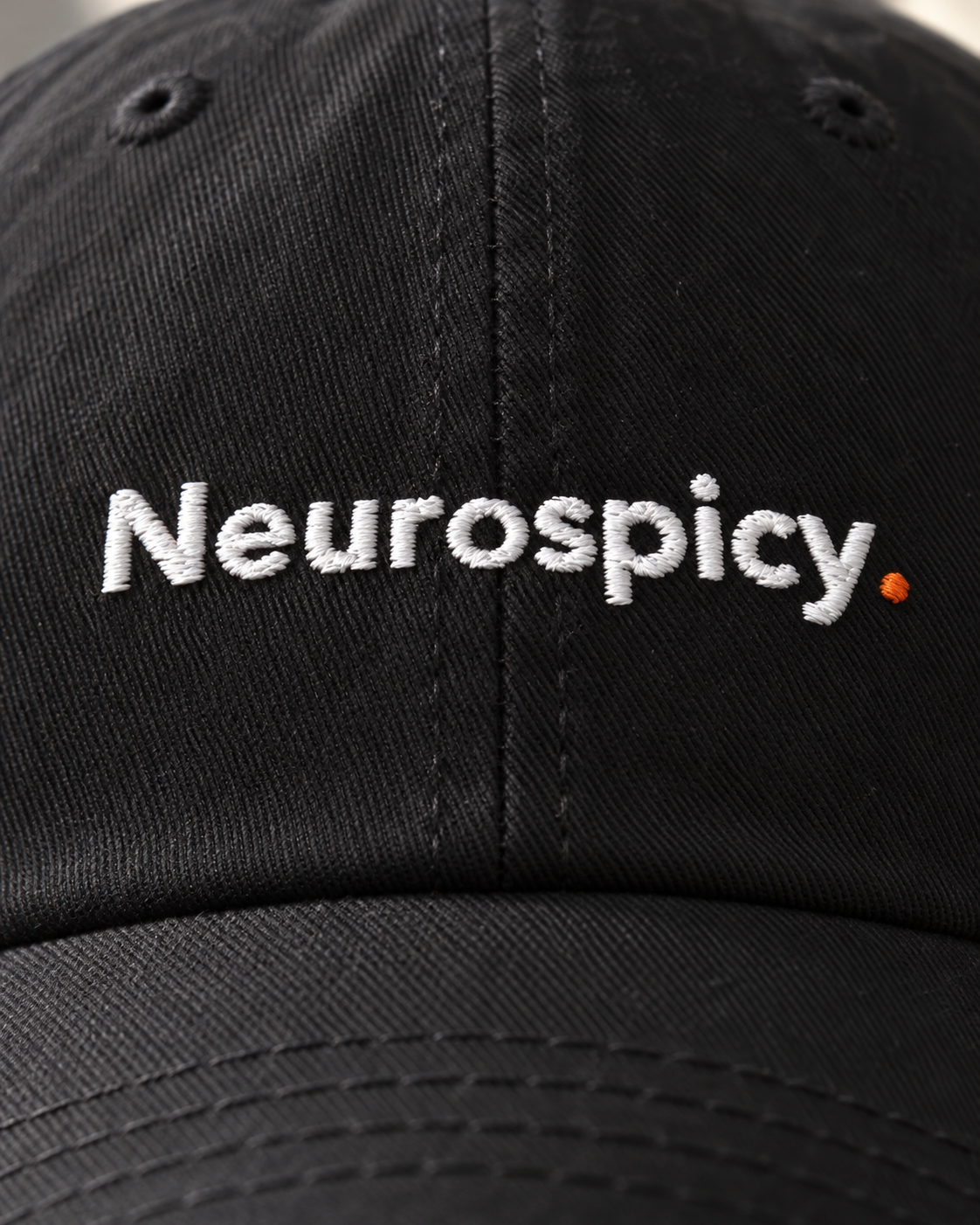 Close-up of the Neurospicy. embroidery on the black cap
