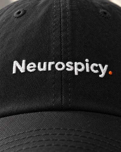Close-up of the Neurospicy. embroidery on the black cap