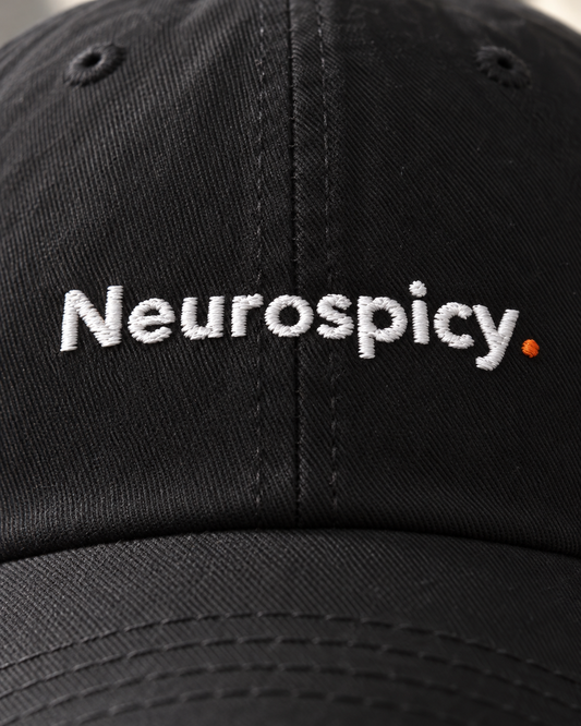 Close-up of the Neurospicy. embroidery on the black cap