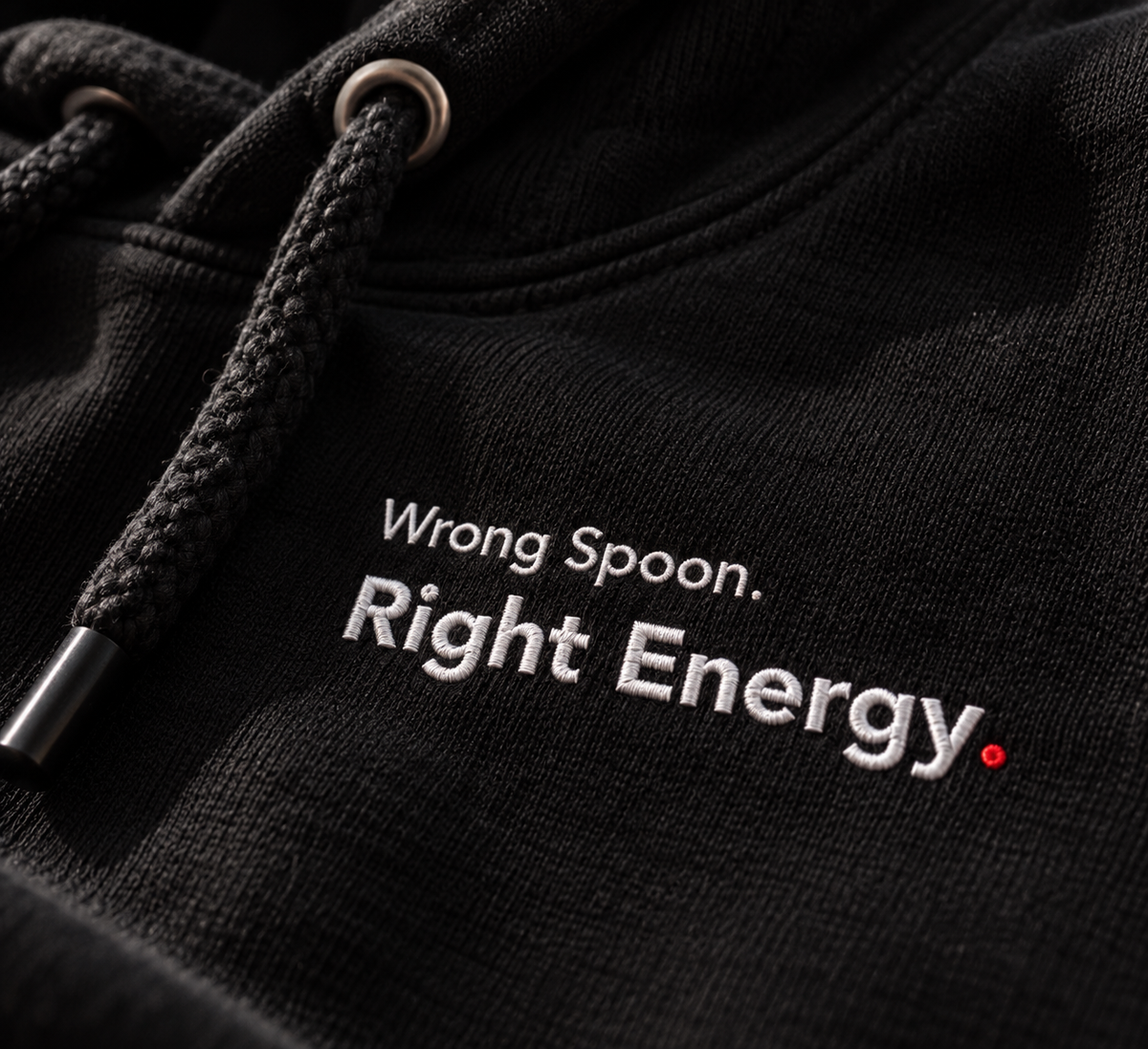 Close-up of Wrong Spoon. Right Energy. embroidery on the black hoodie