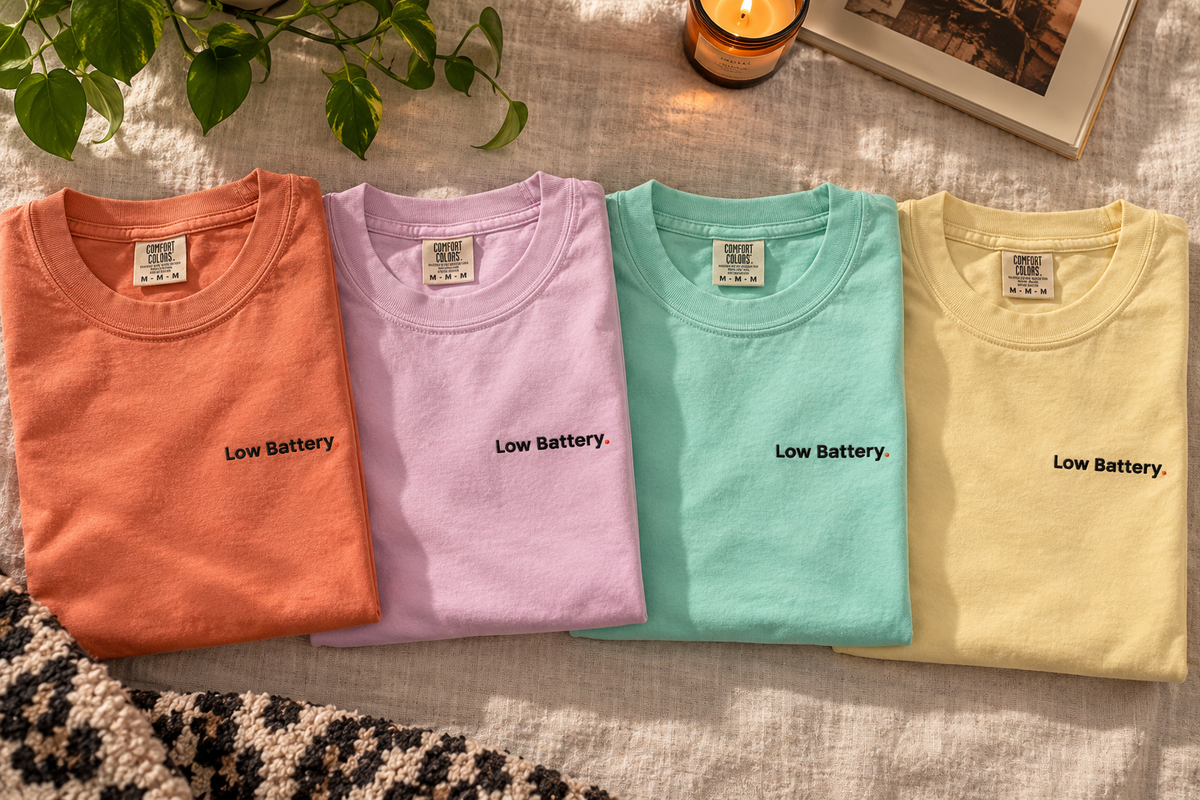 Low Battery. Pastel Pop tees laid flat in Terracotta, Orchid, Chalky Mint and Butter