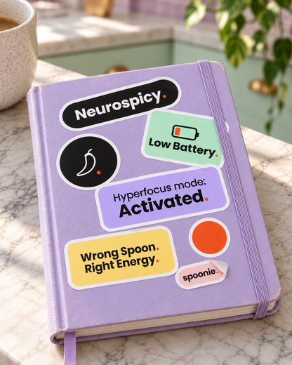 All seven Wrong Spoon stickers stuck on a lilac notebook