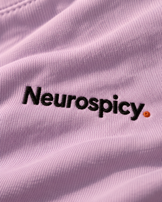 Close-up of the Neurospicy. embroidery on Orchid fabric