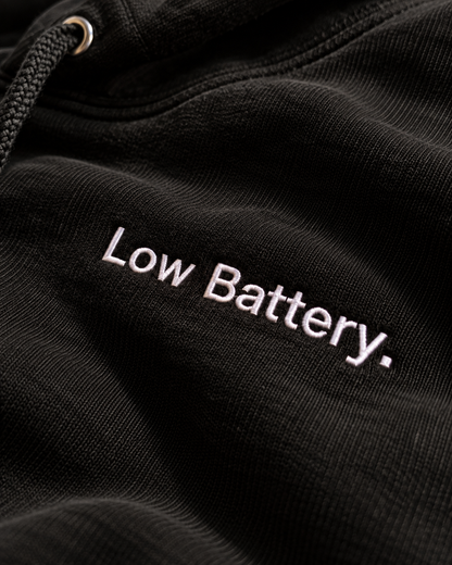 Close-up of the Low Battery. embroidery on the black hoodie