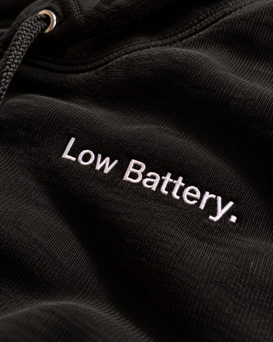 Close-up of the Low Battery. embroidery on the black hoodie