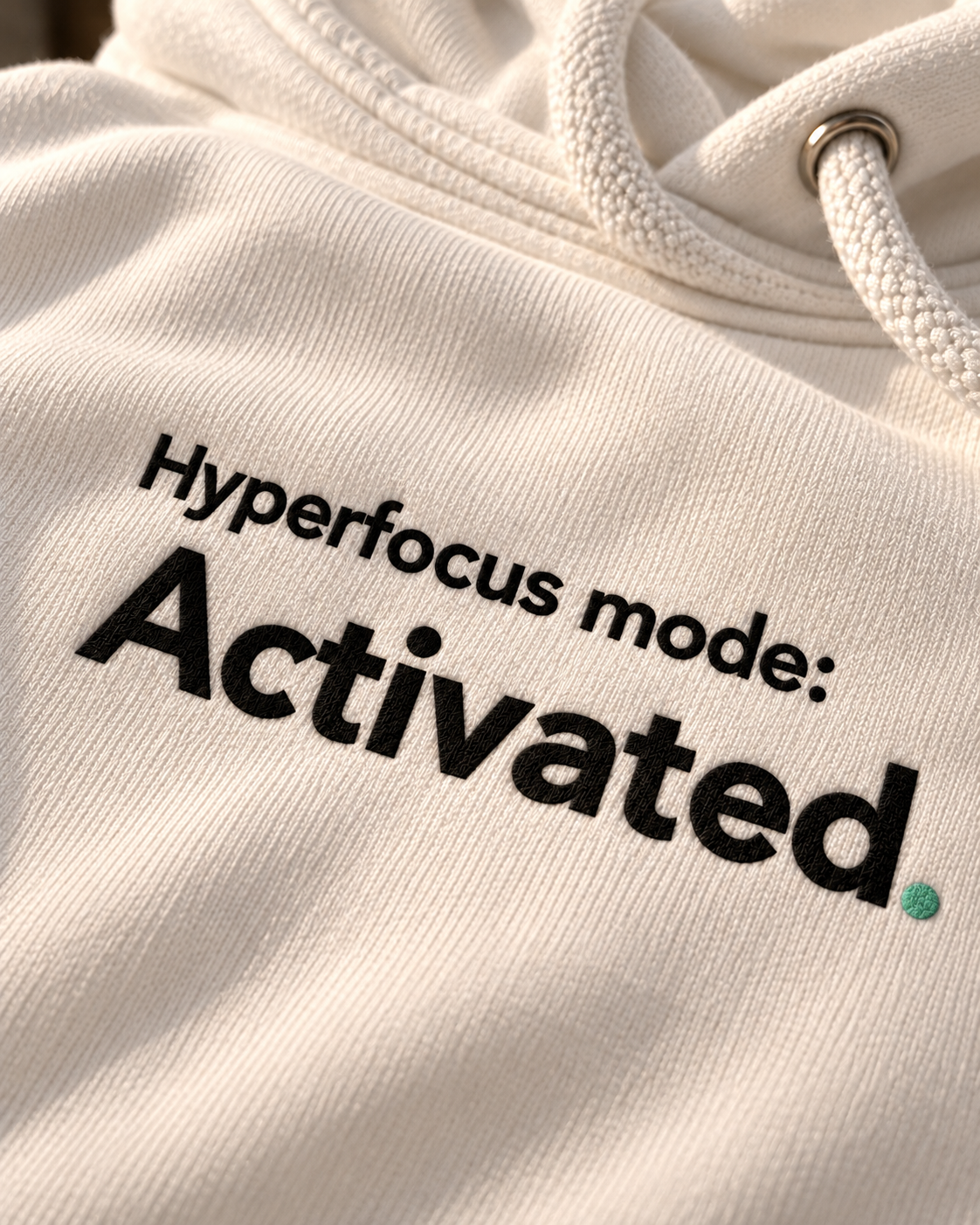 Close-up of the Hyperfocus mode: Activated. embroidery on the white hoodie