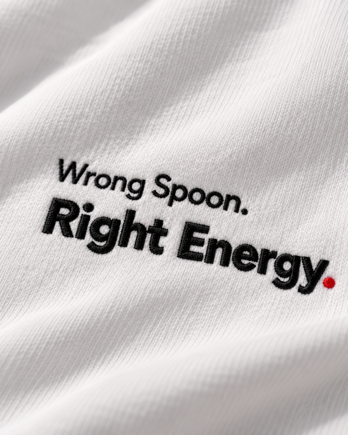 Close-up of the Wrong Spoon. Right Energy. embroidery on the white hoodie