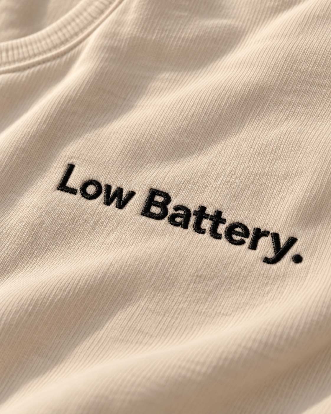 Close-up of the Low Battery. embroidery on Vintage White fabric